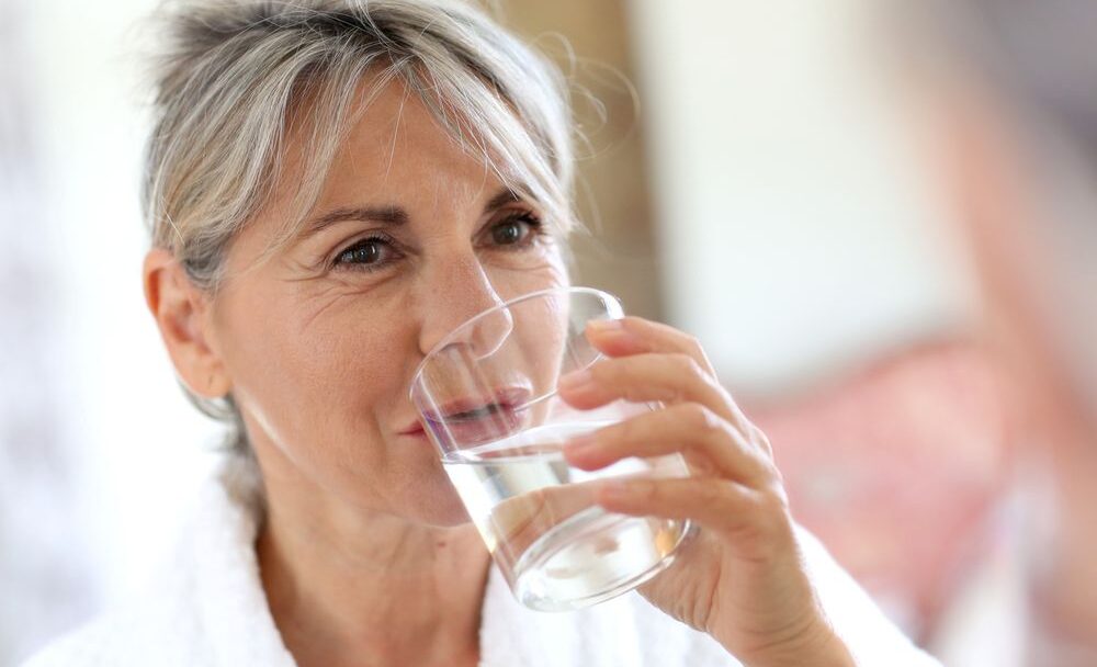 Senior,Woman,Drinking,Water,In,The,Morning